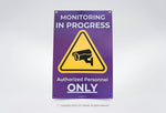 Monitoring in Progress sign with camera icon and Authorized Personnel Only text on purple background